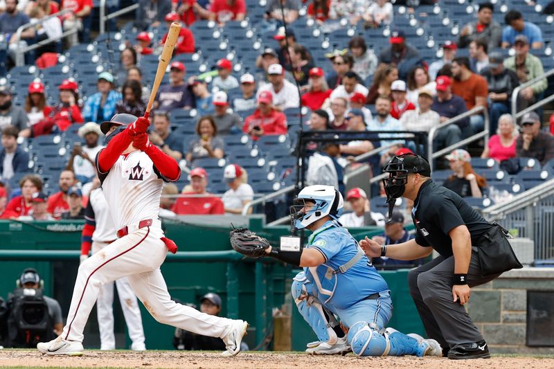 May 5, 2024; Washington, District of Columbia, USA; Washington Nationals outfielder Jacob Young (30) doubles against the Toronto Blue Jays during the sixth inning at Nationals Park. Mandatory Credit: Geoff Burke-USA TODAY Sports