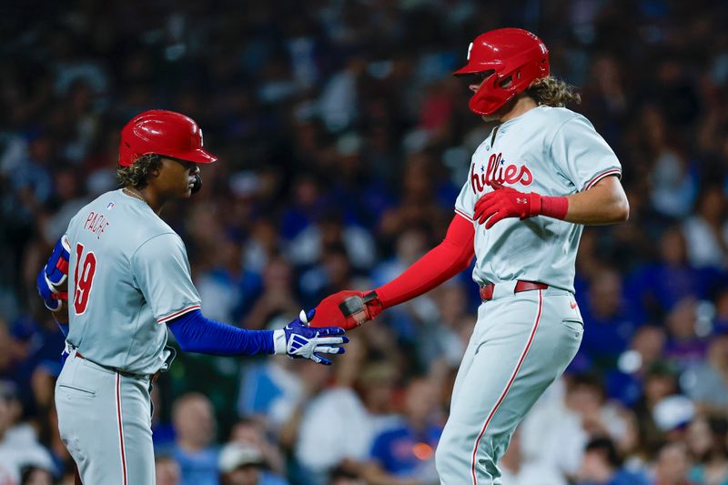 Jul 3, 2024; Chicago, Illinois, USA; Philadelphia Phillies third baseman Alec Bohm (28) celebrates with outfielder Cristian Pache (19) after scoring against the Chicago Cubs during the eight inning at Wrigley Field. Mandatory Credit: Kamil Krzaczynski-USA TODAY Sports