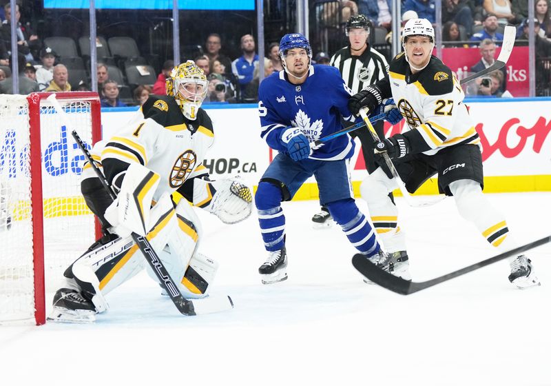 Nov 5, 2024; Toronto, Ontario, CAN; Toronto Maple Leafs left wing Nicholas Robertson (89) battles with Boston Bruins defenseman Hampus Lindholm (27) in front of goaltender Jeremy Swayman (1) during the first period at Scotiabank Arena. Mandatory Credit: Nick Turchiaro-Imagn Imagess