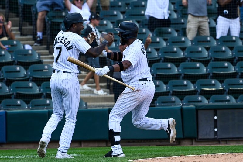 Aug 23, 2023; Chicago, Illinois, USA;  Chicago White Sox shortstop Tim Anderson (7), left, celebrates with Chicago White Sox shortstop Elvis Andrus (1) after scoring during the tenth inning to beat the Seattle Mariners at Guaranteed Rate Field. Mandatory Credit: Matt Marton-USA TODAY Sports