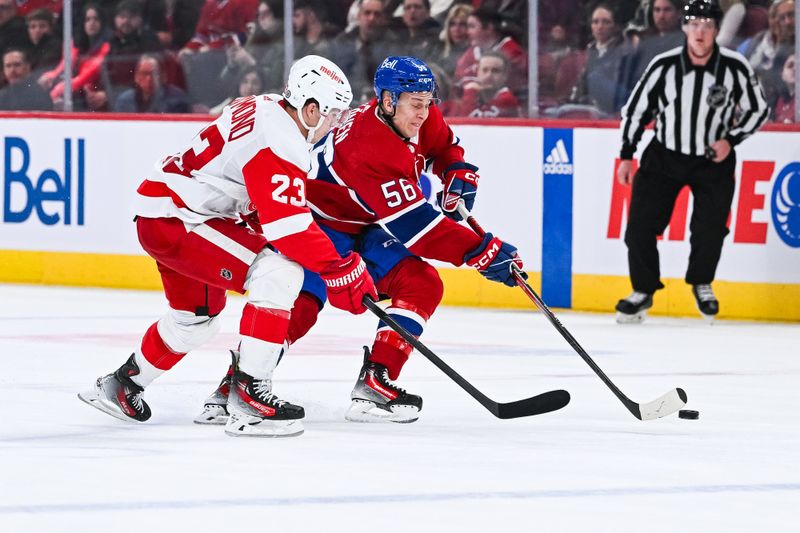 Dec 2, 2023; Montreal, Quebec, CAN; Montreal Canadiens right wing Jesse Ylonen (56) plays the puck against Detroit Red Wings left wing Lucas Raymond (23) during the third period at Bell Centre. Mandatory Credit: David Kirouac-USA TODAY Sports