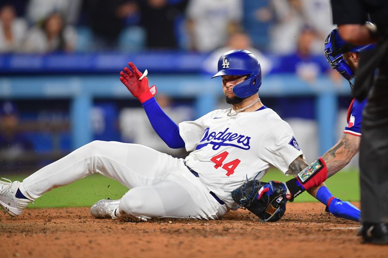 Jun 12, 2024; Los Angeles, California, USA; Los Angeles Dodgers center fielder Andy Pages (44) is out at home against the tag of Texas Rangers catcher Jonah Heim (28) during the ninth inning at Dodger Stadium. Mandatory Credit: Gary A. Vasquez-USA TODAY Sports