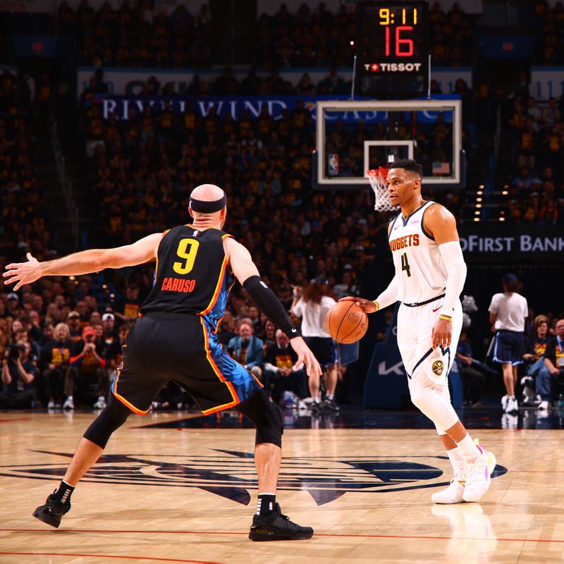 OKLAHOMA CITY, OK - MAY 5:  Russell Westbrook #4 of the Denver Nuggets dribbles the ball during the game white Alex Caruso #9 of the Oklahoma City Thunder defends during Round Two Game One of the 2025 NBA Playoffs on MAY 5, 2025 at Paycom Center in Oklahoma City, Oklahoma. NOTE TO USER: User expressly acknowledges and agrees that, by downloading and or using this photograph, User is consenting to the terms and conditions of the Getty Images License Agreement. Mandatory Copyright Notice: Copyright 2025 NBAE (Photo by Zach Beeker/NBAE via Getty Images)