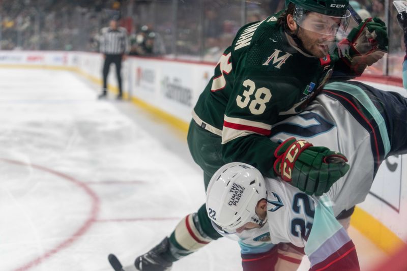 Apr 18, 2024; Saint Paul, Minnesota, USA; Minnesota Wild right wing Ryan Hartman (38) checks Seattle Kraken right wing Oliver Bjorkstrand (22) in the corner in the first period at Xcel Energy Center. Mandatory Credit: Matt Blewett-USA TODAY Sports