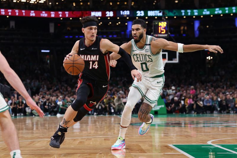 BOSTON, MASSACHUSETTS - OCTOBER 27: Tyler Herro #14 of the Miami Heat drives to the basket past Jayson Tatum #0 of the Boston Celtics at TD Garden on October 27, 2023 in Boston, Massachusetts. NOTE TO USER: User expressly acknowledges and agrees that, by downloading and or using this photograph, User is consenting to the terms and conditions of the Getty Images License Agreement. (Photo by Maddie Schroeder/Getty Images)