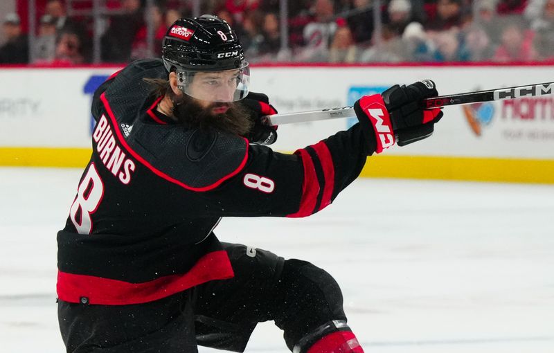 Jan 15, 2024; Raleigh, North Carolina, USA; Carolina Hurricanes defenseman Brent Burns (8) takes a shot against the Los Angeles Kings during the first period at PNC Arena. Mandatory Credit: James Guillory-USA TODAY Sports