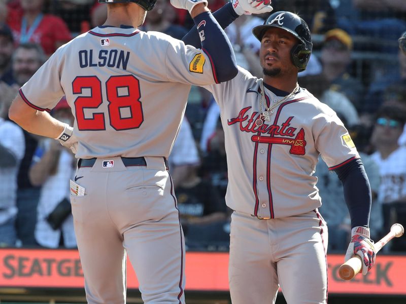 May 10, 2025; Pittsburgh, Pennsylvania, USA;  Atlanta Braves second baseman Ozzie Albies (right) congratulates first baseman Matt Olson (28) crossing hime plate on a solo home run against the Pittsburgh Pirates during the third inning at PNC Park. Mandatory Credit: Charles LeClaire-Imagn Images