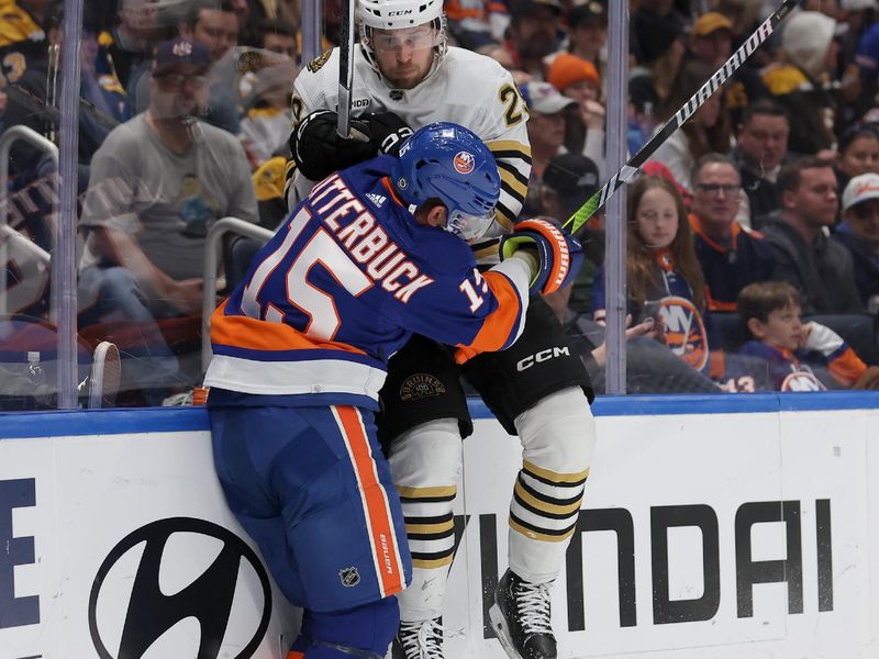 Mar 2, 2024; Elmont, New York, USA; New York Islanders right wing Cal Clutterbuck (15) and Boston Bruins defenseman Parker Wotherspoon (29) collide during the second period at UBS Arena. Mandatory Credit: Brad Penner-USA TODAY Sports