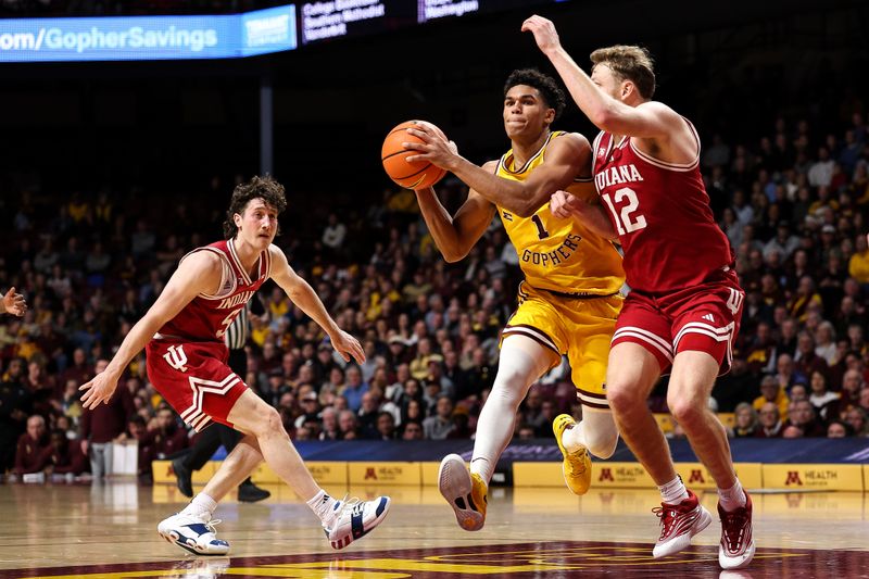 Dec 3, 2025; Minneapolis, Minnesota, USA; Minnesota Golden Gophers guard Isaac Asuma (1) drives towards the basket as Indiana Hoosiers forward Tucker Devries (12) defends during the first half at Williams Arena. Mandatory Credit: Matt Krohn-Imagn Images