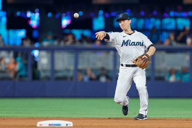 Jun 4, 2023; Miami, Florida, USA; Miami Marlins shortstop Joey Wendle (18) throws the baseball to first baseman Yuli Gurriel (not pictured) to retire Oakland Athletics shortstop Nick Allen (not pictured) during the fifth inning at loanDepot Park. Mandatory Credit: Sam Navarro-USA TODAY Sports