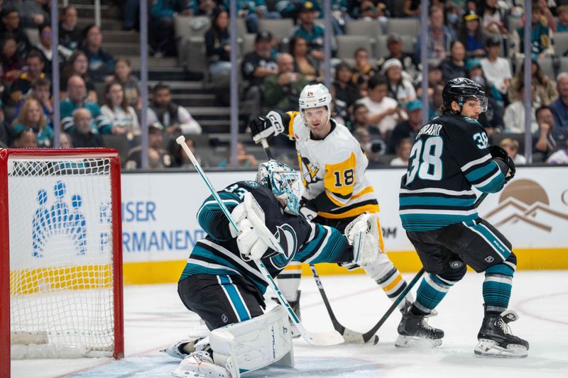 Oct 18, 2025; San Jose, California, USA; San Jose Sharks defenseman Mario Ferraro (38) deflects the puck for a save while Pittsburgh Penguins center Tommy Novak (18) battles for position for the rebound during first perioid at SAP Center at San Jose. Mandatory Credit: Neville E. Guard-Imagn Images