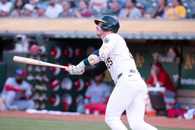 Jul 2, 2024; Oakland, California, USA; Oakland Athletics outfielder Brent Rooker (25) hits a home run against the Los Angeles Angels during the fourth inning at Oakland-Alameda County Coliseum. Mandatory Credit: Ed Szczepanski-USA TODAY Sports