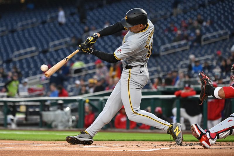 Apr 3, 2024; Washington, District of Columbia, USA; Pittsburgh Pirates left fielder Bryan Reynolds (10) puts the ball in play against the Washington Nationals during the first inning at Nationals Park. Mandatory Credit: Rafael Suanes-USA TODAY Sports