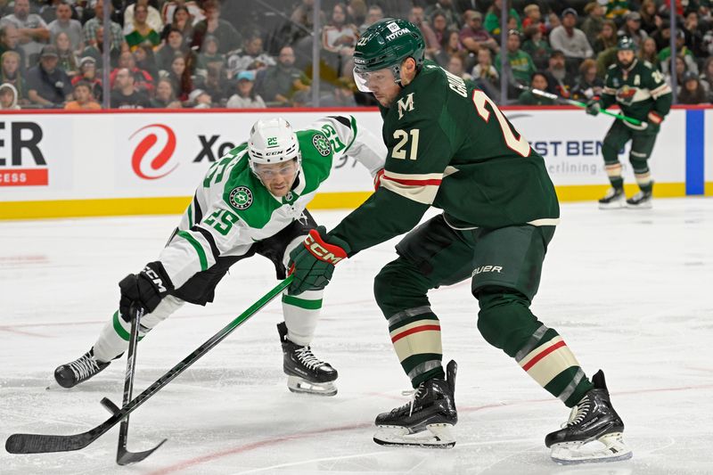 Sep 29, 2024; Saint Paul, Minnesota, USA;  Dallas Stars forward Matej Blumel (25) poke-checks the puck away from Minnesota Wild forward Brendan Gaunce (21) during the second period at Xcel Energy Center. Mandatory Credit: Nick Wosika-Imagn Images