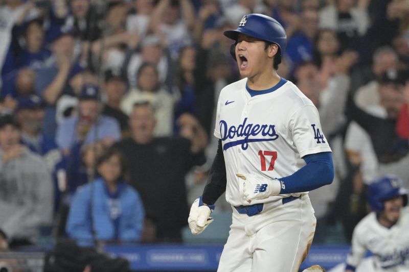 Sep 26, 2024; Los Angeles, California, USA;Los Angeles Dodgers designated hitter Shohei Ohtani (17) scores on a RBI single by shortstop Mookie Betts (50) in the seventh inning against the San Diego Padres at Dodger Stadium. Mandatory Credit: Jayne Kamin-Oncea-Imagn Images