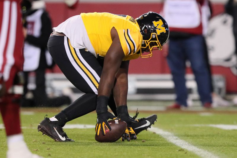 Nov 24, 2023; Fayetteville, Arkansas, USA; Missouri Tigers defensive lineman Jay Jernigan (0) picks up a fumble and returns it for a touchdown in the third quarter against the Arkansas Razorbacks at Donald W. Reynolds Razorback Stadium. Missouri won 48-14. Mandatory Credit: Nelson Chenault-USA TODAY Sports