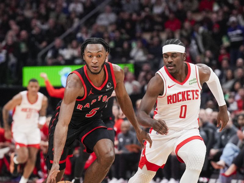 TORONTO, ON - FEBRUARY 9: Immanuel Quickley #5 of the Toronto Raptors and Aaron Holiday #0 of the Houston Rockets during the first half of their basketball game at the Scotiabank Arena on February 9, 2024 in Toronto, Ontario, Canada. NOTE TO USER: User expressly acknowledges and agrees that, by downloading and/or using this Photograph, user is consenting to the terms and conditions of the Getty Images License Agreement. (Photo by Mark Blinch/Getty Images)