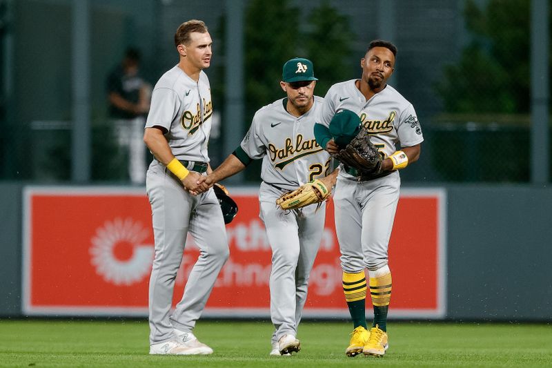 Jul 28, 2023; Denver, Colorado, USA; Oakland Athletics center fielder JJ Bleday (33) and right fielder Ramon Laureano (22) and left fielder Tony Kemp (5) celebrate after the game against the Colorado Rockies at Coors Field. Mandatory Credit: Isaiah J. Downing-USA TODAY Sports