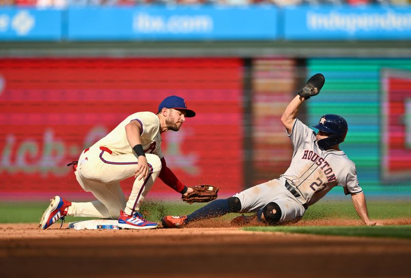Aug 28, 2024; Philadelphia, Pennsylvania, USA; Houston Astros infielder Jose Altuve (27) is caught stealing against Philadelphia Phillies shortstop Trea Turner (7) in the third inning at Citizens Bank Park. Mandatory Credit: Kyle Ross-USA TODAY Sports