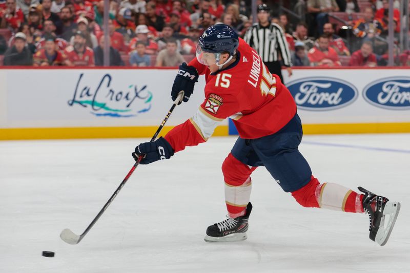 Oct 9, 2025; Sunrise, Florida, USA; Florida Panthers center Anton Lundell (15) shoots the puck against the Philadelphia Flyers during the second period at Amerant Bank Arena. Mandatory Credit: Sam Navarro-Imagn Images
