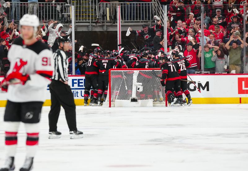 Apr 29, 2025; Raleigh, North Carolina, USA; Carolina Hurricanes center Sebastian Aho (20) scores the game winning goal in the second overtime against the New Jersey Devils in game five of the first round of the 2025 Stanley Cup Playoffs at Lenovo Center. Mandatory Credit: James Guillory-Imagn Images