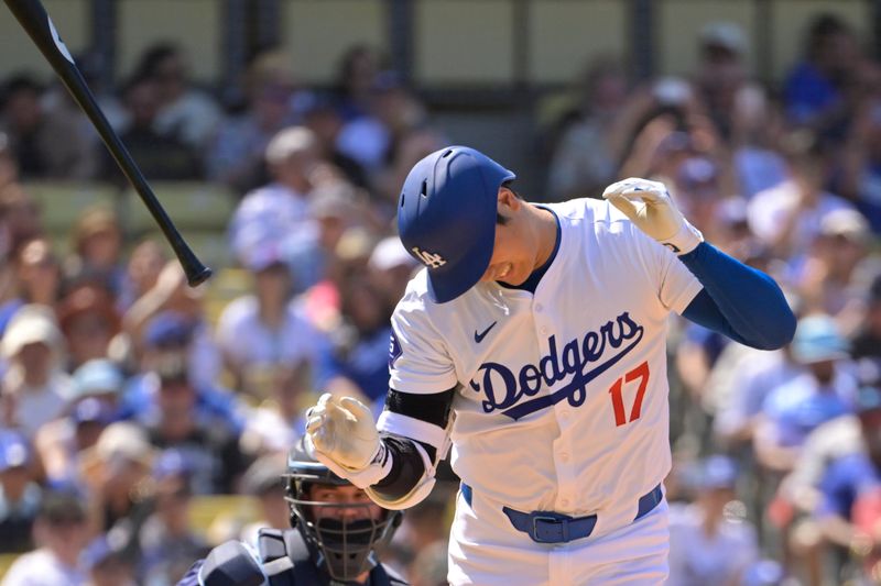 Aug 25, 2024; Los Angeles, California, USA;  The bat flies out of the hands of Los Angeles Dodgers designated hitter Shohei Ohtani (17) after he was hit by a pitch in the eighth inning against the Tampa Bay Rays at Dodger Stadium. Mandatory Credit: Jayne Kamin-Oncea-USA TODAY Sports