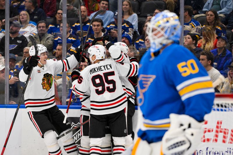 Oct 15, 2025; St. Louis, Missouri, USA; Chicago Blackhawks center Jason Dickinson (16) is congratulated by teammates after scoring against St. Louis Blues goaltender Jordan Binnington (50) during the second period at Enterprise Center. Mandatory Credit: Jeff Curry-Imagn Images