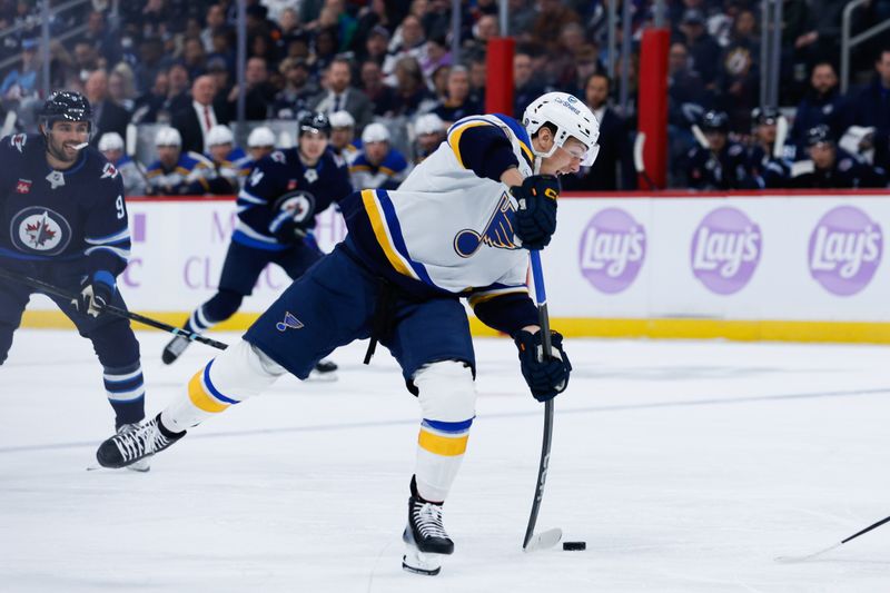 Dec 3, 2024; Winnipeg, Manitoba, CAN;  St. Louis Blues forward Zack Bolduc (76) takes a shot on the Winnipeg Jets net during the first period at Canada Life Centre. Mandatory Credit: Terrence Lee-Imagn Images