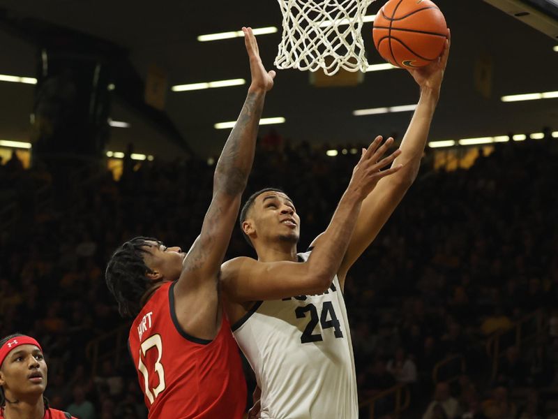 Jan 15, 2023; Iowa City, Iowa, USA; Iowa Hawkeyes forward Kris Murray (24) draws a foul from Maryland Terrapins guard Hakim Hart (13) at Carver-Hawkeye Arena.  The Hawkeyes beat the Terrapins 81-67. Mandatory Credit: Reese Strickland-USA TODAY Sports