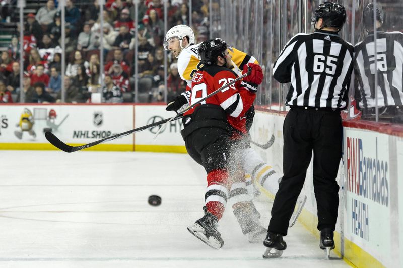 Apr 2, 2024; Newark, New Jersey, USA; New Jersey Devils right wing Timo Meier (28) checks Pittsburgh Penguins defenseman Marcus Pettersson (28) during the third period at Prudential Center. Mandatory Credit: John Jones-USA TODAY Sports