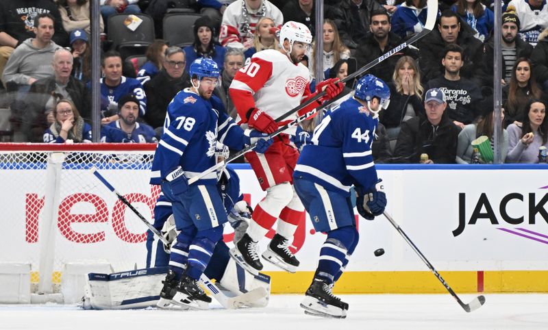 Jan 14, 2024; Toronto, Ontario, CAN;  Detroit Red Wings forward Joe Veleno (90) jumps to get out of the way of the puck as Toronto Maple Leafs defensemen Morgan Rielly (44) and TJ Brodie (78) defend their goal area in the third period at Scotiabank Arena. Mandatory Credit: Dan Hamilton-USA TODAY Sports