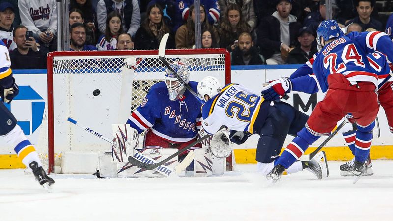 Nov 25, 2024; New York, New York, USA; St. Louis Blues left wing Nathan Walker (26) takes a shot at New York Rangers goalie Igor Shesterkin (31) during the second period at Madison Square Garden. Mandatory Credit: Danny Wild-Imagn Images