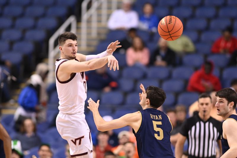 Mar 7, 2023; Greensboro, NC, USA; Virginia Tech Hokies guard Hunter Cattoor (0) passes the ball as Notre Dame Fighting Irish guard Cormac Ryan (5) defends in the first half at Greensboro Coliseum. Mandatory Credit: Bob Donnan-USA TODAY Sports