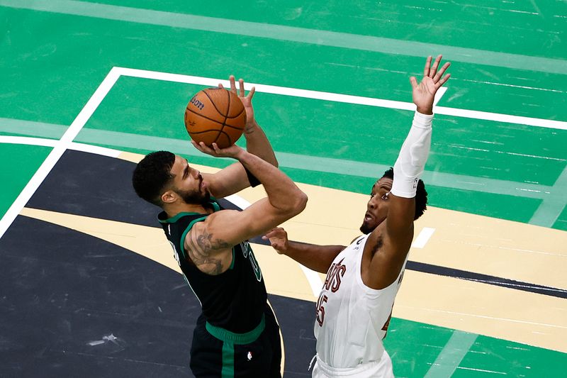 BOSTON, MASSACHUSETTS - NOVEMBER 19: Jayson Tatum #0 of the Boston Celtics shoots against Donovan Mitchell #45 of the Cleveland Cavaliers during the second quarter of the Emirates NBA Cup at TD Garden on November 19, 2024 in Boston, Massachusetts. NOTE TO USER: User expressly acknowledges and agrees that, by downloading and or using this photograph, User is consenting to the terms and conditions of the Getty Images License Agreement.  (Photo by Winslow Townson/Getty Images)