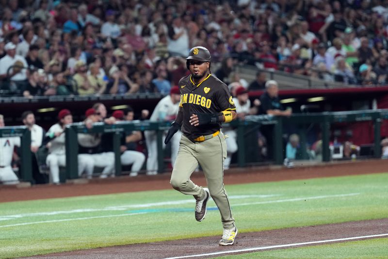 Sep 27, 2024; Phoenix, Arizona, USA; San Diego Padres first base Luis Arraez (4) scores a run against the Arizona Diamondbacks during the first inning at Chase Field. Mandatory Credit: Joe Camporeale-Imagn Images