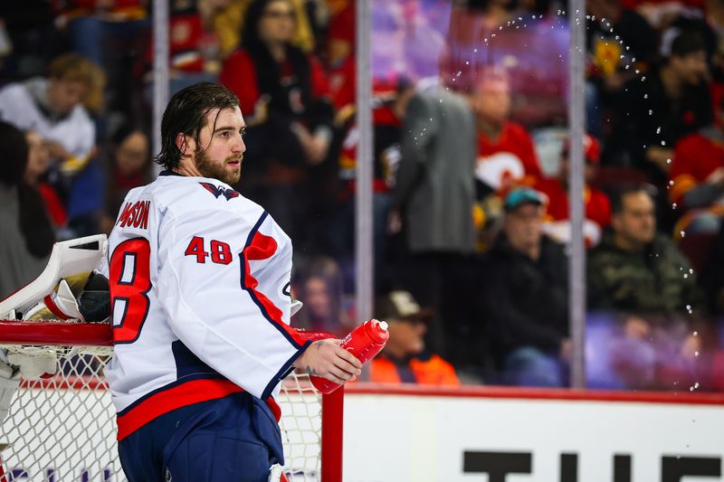 Jan 28, 2025; Calgary, Alberta, CAN; Washington Capitals goaltender Logan Thompson (48) sprays water during the second period TV timeout against the Calgary Flames at Scotiabank Saddledome. Mandatory Credit: Sergei Belski-Imagn Images