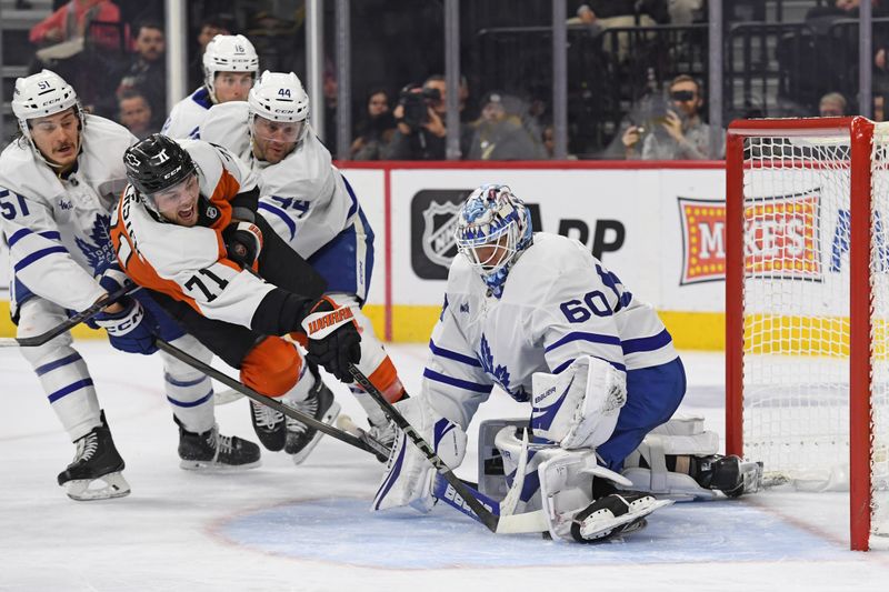 Jan 7, 2025; Philadelphia, Pennsylvania, USA; Toronto Maple Leafs goaltender Joseph Woll (60) makes a save against Philadelphia Flyers right wing Tyson Foerster (71) during the third period at Wells Fargo Center. Mandatory Credit: Eric Hartline-Imagn Images