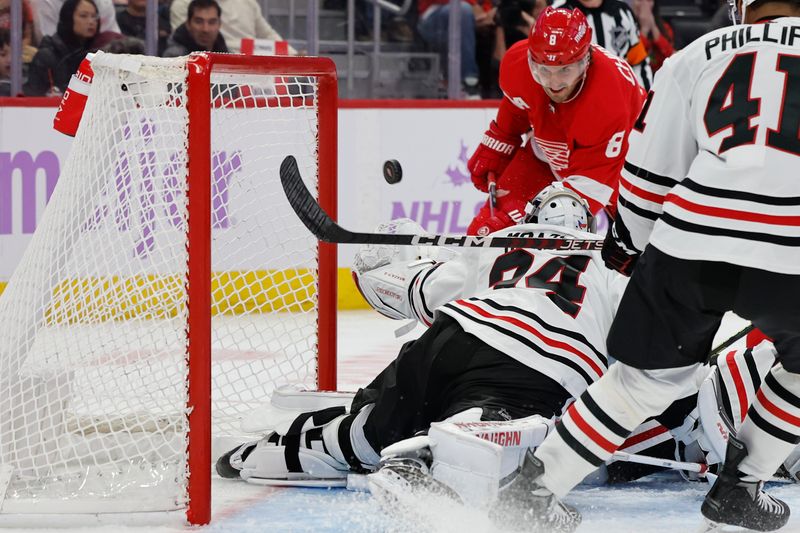 Nov 30, 2023; Detroit, Michigan, USA; Detroit Red Wings defenseman Ben Chiarot (8) scores a goal on Chicago Blackhawks goaltender Petr Mrazek (34) in the second period at Little Caesars Arena. Mandatory Credit: Rick Osentoski-USA TODAY Sports