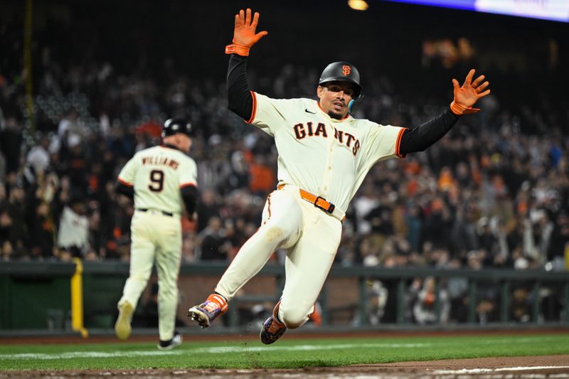 May 1, 2025; San Francisco, California, USA; San Francisco Giants shortstop Willy Adames (2) slides home against the Colorado Rockies in the sixth inning at Oracle Park. Mandatory Credit: Eakin Howard-Imagn Images