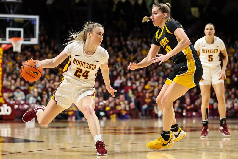 Feb 28, 2024; Minneapolis, Minnesota, USA; Minnesota Golden Gophers forward Mallory Heyer (24) dribbles as Iowa Hawkeyes guard Kate Martin (20) defends during the first half at Williams Arena. Mandatory Credit: Matt Krohn-USA TODAY Sports