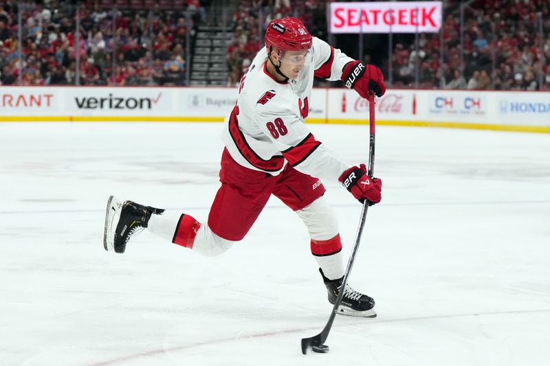 Nov 10, 2023; Sunrise, Florida, USA; Carolina Hurricanes center Martin Necas (88) shoots the puck against the Florida Panthers during the first period at Amerant Bank Arena. Mandatory Credit: Jasen Vinlove-USA TODAY Sports