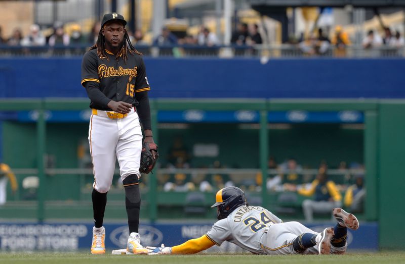 Apr 25, 2024; Pittsburgh, Pennsylvania, USA;  Milwaukee Brewers catcher William Contreras (24) steals second base without a throw as Pittsburgh Pirates shortstop Oneil Cruz (15) looks on during the fifth inning at PNC Park. Mandatory Credit: Charles LeClaire-USA TODAY Sports