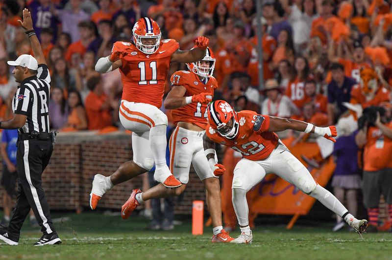 Sep 16, 2023; Clemson, South Carolina; Clemson defensive lineman T.J. Parker (12) reacts with defensive lineman Peter Woods (11) after sacking Florida Atlantic quarterback Daniel Richardson (10) during the second quarter against Florida Atlantic at Memorial Stadium.  Mandatory Credit: Ken Ruinard-USA TODAY NETWORK