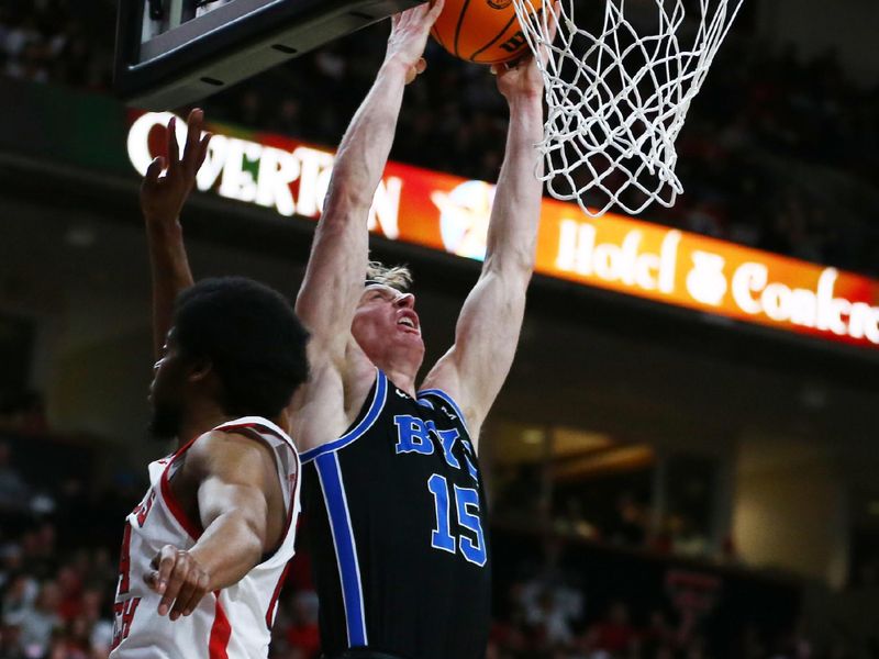 Jan 20, 2024; Lubbock, Texas, USA;  Brigham Young Cougars guard Richie Saunders (15) goes to the basket against Texas Tech Red Raiders guard Kerwin Walton (24) in the first half at United Supermarkets Arena. Mandatory Credit: Michael C. Johnson-USA TODAY Sports