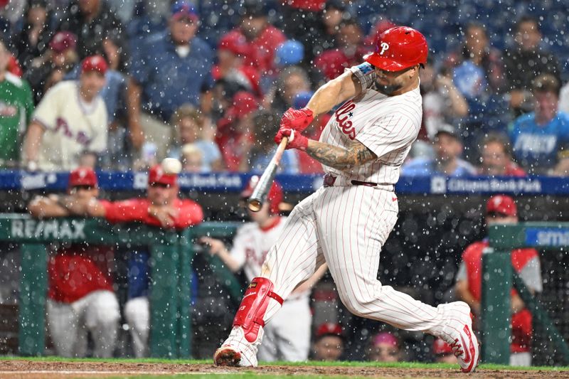 Sep 23, 2025; Philadelphia, Pennsylvania, USA; Philadelphia Phillies catcher Rafael Marchán (13) hits a single during the ninth inning against the Miami Marlins at Citizens Bank Park. Mandatory Credit: Eric Hartline-Imagn Images