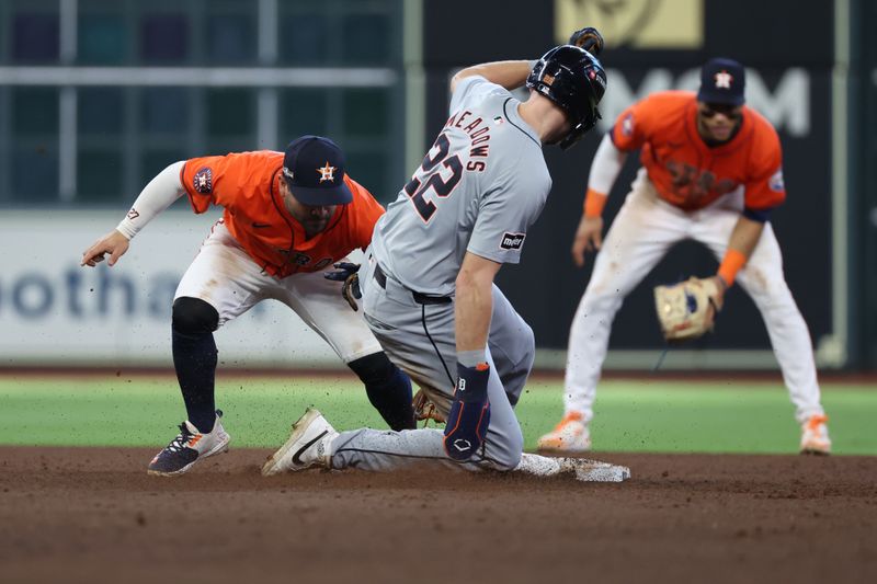 Oct 2, 2024; Houston, Texas, USA; Houston Astros shortstop Jeremy Pena (3) tags  Detroit Tigers catcher Jake Rogers (34) out at second base on a fielders choice during the ninth inning of game two of the Wildcard round for the 2024 MLB Playoffs at Minute Maid Park. Mandatory Credit: Thomas Shea-Imagn Images