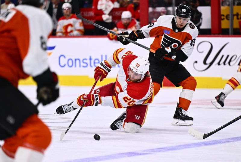 Jan 6, 2024; Philadelphia, Pennsylvania, USA; Calgary Flames center Blake Coleman (20) dives for the puck against Philadelphia Flyers right wing Cam Atkinson (89) in the third period at Wells Fargo Center. Mandatory Credit: Kyle Ross-USA TODAY Sports