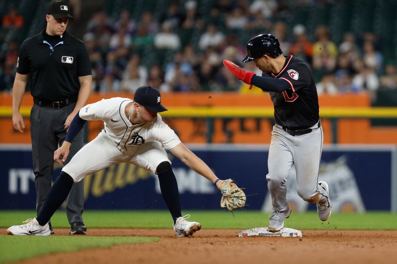 Sep 17, 2025; Detroit, Michigan, USA; Cleveland Guardians left fielder Steven Kwan (38) steals second base while  Detroit Tigers shortstop Trey Sweeney (27) tries to tag him out during the ninth inning at Comerica Park. Mandatory Credit: Brian Bradshaw Sevald-Imagn Images