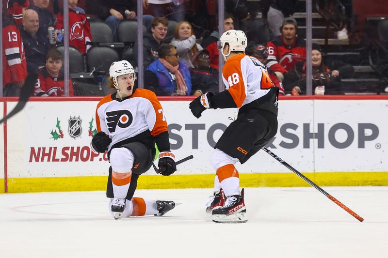 Dec 19, 2023; Newark, New Jersey, USA; Philadelphia Flyers right wing Owen Tippett (74) celebrates his game-winning goal against the New Jersey Devils during overtime at Prudential Center. Mandatory Credit: Ed Mulholland-USA TODAY Sports