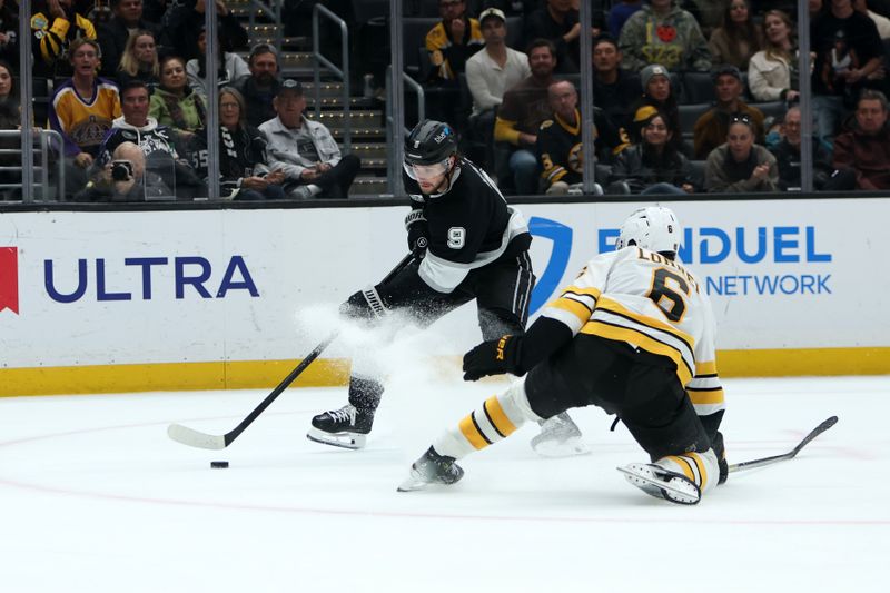 Nov 21, 2025; Los Angeles, California, USA;  Los Angeles Kings right wing Adrian Kempe (9) controls the puck against Boston Bruins defenseman Mason Lohrei (6) during the overtime at Crypto.com Arena. Mandatory Credit: Kiyoshi Mio-Imagn Images